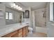 Bathroom with updated vanity, light fixtures, shower and bathtub at 4225 Barret Ave, Plant City, FL 33566