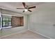 Neutral bedroom with a ceiling fan and a large window with lots of light at 4225 Barret Ave, Plant City, FL 33566