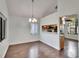 Well-lit dining room featuring wood floors, a chandelier, and a view to an adjacent room at 4225 Barret Ave, Plant City, FL 33566