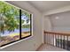 Hallway with a picturesque lake view from the large window at 4225 Barret Ave, Plant City, FL 33566