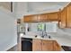 Bright kitchen with stainless steel appliances, a double sink, and an adjacent open-concept room at 4225 Barret Ave, Plant City, FL 33566