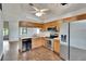 Spacious kitchen featuring stainless steel appliances, wood cabinetry, and a view of the water at 4225 Barret Ave, Plant City, FL 33566