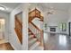 Spacious living room with hardwood floors, vaulted ceilings, fireplace, staircase, and views of the lake at 4225 Barret Ave, Plant City, FL 33566