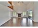Living room with hardwood floors, fireplace, staircase, and a sliding glass door to the outdoors at 4225 Barret Ave, Plant City, FL 33566
