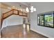 Open concept living area with staircase, balcony, high ceilings, and hardwood floors at 4225 Barret Ave, Plant City, FL 33566