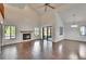 Open living room features hardwood floors, fireplace, sliding door, kitchen, and dining area at 4225 Barret Ave, Plant City, FL 33566