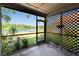Screened-in porch providing a serene view of the lake and surrounding greenery at 4225 Barret Ave, Plant City, FL 33566