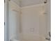 Bright bathroom shower with white tile surround and updated fixtures at 4225 Barret Ave, Plant City, FL 33566