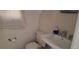 Compact white bathroom with white tile, toilet, and sink with modern faucet at 4331 16Th S Ave, St Petersburg, FL 33711