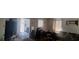 Panoramic view of the living room showing dark couches and some exposed furniture at 4331 16Th S Ave, St Petersburg, FL 33711
