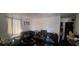 View of the living room with a large dark sofa and a ceiling fan at 4331 16Th S Ave, St Petersburg, FL 33711