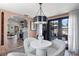 Cozy dining room with white chairs, stylish light fixture, and seamless flow to the kitchen at 4829 20Th N Ave, St Petersburg, FL 33713
