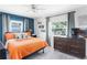 Cozy bedroom with bright orange comforter and stylish decor; features a ceiling fan and modern dresser at 5254 23Rd N Ave, St Petersburg, FL 33710