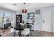 A well-lit dining area features a round table, stylish lighting, and a view of an office workspace at 5254 23Rd N Ave, St Petersburg, FL 33710