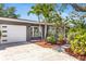 Charming home exterior showcasing a well-manicured lawn, fresh mulch, and a convenient garage at 5254 23Rd N Ave, St Petersburg, FL 33710