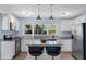 Bright kitchen featuring white cabinets, granite countertops, and stainless steel appliances, offering a modern design at 5254 23Rd N Ave, St Petersburg, FL 33710