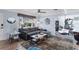 Bright living room with a gray sofa, a modern coffee table and a hanging chair near the dining area at 5254 23Rd N Ave, St Petersburg, FL 33710