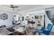 Open-concept living room and kitchen featuring a hanging chair, breakfast bar, and modern design elements at 5254 23Rd N Ave, St Petersburg, FL 33710