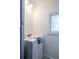 Bright bathroom with a white vanity, soft lighting and a window for natural lighting at 56 W Park St, Tarpon Springs, FL 34689
