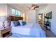 Bright bedroom with soft carpet, ample natural light, and a ceiling fan at 56 W Park St, Tarpon Springs, FL 34689