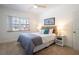 This naturally lit bedroom includes coastal decor and soft carpet at 56 W Park St, Tarpon Springs, FL 34689
