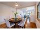 Cozy dining room showcasing hardwood floors, table with place settings, and a view into the living area, ideal for entertaining at 56 W Park St, Tarpon Springs, FL 34689