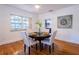 Cozy dining room with hardwood floors, a round table, four chairs, and a decorative painting, creating a warm ambiance at 56 W Park St, Tarpon Springs, FL 34689