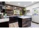 Modern kitchen with a wood accent wall, island, and ample counter space, offering a stylish and functional cooking area at 56 W Park St, Tarpon Springs, FL 34689