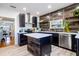 Modern kitchen featuring stainless steel appliances, wood accent wall, and a central island at 56 W Park St, Tarpon Springs, FL 34689