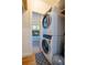 This laundry closet has a stacked washer and dryer and leads to a bedroom at 56 W Park St, Tarpon Springs, FL 34689