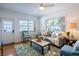 Bright and airy living room with hardwood floors, complemented by a comfortable couch and natural light at 56 W Park St, Tarpon Springs, FL 34689