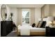 Bright bedroom with a large window, modern decor, comfortable bed, decorative pillows, and a dresser with a mirror at 5611 Red Kite Dr, Wimauma, FL 33598