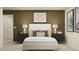 Elegantly designed bedroom showcasing a comfortable bed, contemporary artwork, and stylish bedside tables for a sophisticated retreat at 5611 Red Kite Dr, Wimauma, FL 33598