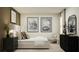 Stylish bedroom featuring a comfortable bed, modern artwork, and a cozy sitting area, creating a serene and sophisticated space at 5611 Red Kite Dr, Wimauma, FL 33598