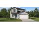Charming two-story home with a two-car garage, beautifully landscaped lawn, and stylish curb appeal at 5611 Red Kite Dr, Wimauma, FL 33598