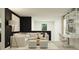 Bright living room with black accent wall, modern furniture, and natural light at 5611 Red Kite Dr, Wimauma, FL 33598