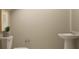 Well-lit powder room with simple fixtures and neutral color scheme at 5611 Red Kite Dr, Wimauma, FL 33598