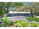 Charming single-story home with lush landscaping, mature trees and a freshly sealed driveway at 600 Betmor Ln, Palm Harbor, FL 34683