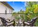 Private balcony featuring outdoor seating with tropical views of trees and the courtyard at 601 Bosphorous Ave, Tampa, FL 33606