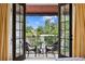 View of the private balcony with seating, accessed through french doors from the bedroom at 601 Bosphorous Ave, Tampa, FL 33606