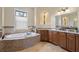 Luxurious bathroom featuring a soaking tub with mosaic tile surround and granite counters at 601 Bosphorous Ave, Tampa, FL 33606