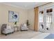 Cozy bedroom featuring plush carpeting, a pair of chairs and a balcony with double french doors at 601 Bosphorous Ave, Tampa, FL 33606