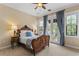 Bedroom featuring a beautiful antique bed frame, blue curtains and double doors to a balcony at 601 Bosphorous Ave, Tampa, FL 33606