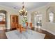 Elegant dining room with glass table, hardwood floors, and easy access to the kitchen and living spaces at 601 Bosphorous Ave, Tampa, FL 33606