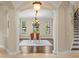 Formal dining room with hardwood floors, modern chandelier, and an arched entryway at 601 Bosphorous Ave, Tampa, FL 33606
