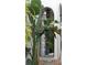 Charming entryway with an ornate wrought iron gate and tropical plants at 601 Bosphorous Ave, Tampa, FL 33606