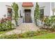 Charming front entrance with a dark wood door, manicured landscaping, and stone steps at 601 Bosphorous Ave, Tampa, FL 33606