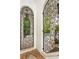 Ornate wrought iron gates create a charming entrance to a lush, tropical garden and courtyard at 601 Bosphorous Ave, Tampa, FL 33606