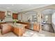 Open kitchen design boasts wooden cabinets, granite countertops, stainless appliances, and an island at 601 Bosphorous Ave, Tampa, FL 33606