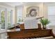 Bright living room featuring a piano, fireplace, and doors opening to a lush outdoor area at 601 Bosphorous Ave, Tampa, FL 33606